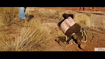 Enormous-rear-end blonde gets her butthole whipped, then gets rough anal sex in dirt and piss -- a real BDSM session outdoors in the Western USA with Rebel Rhyder